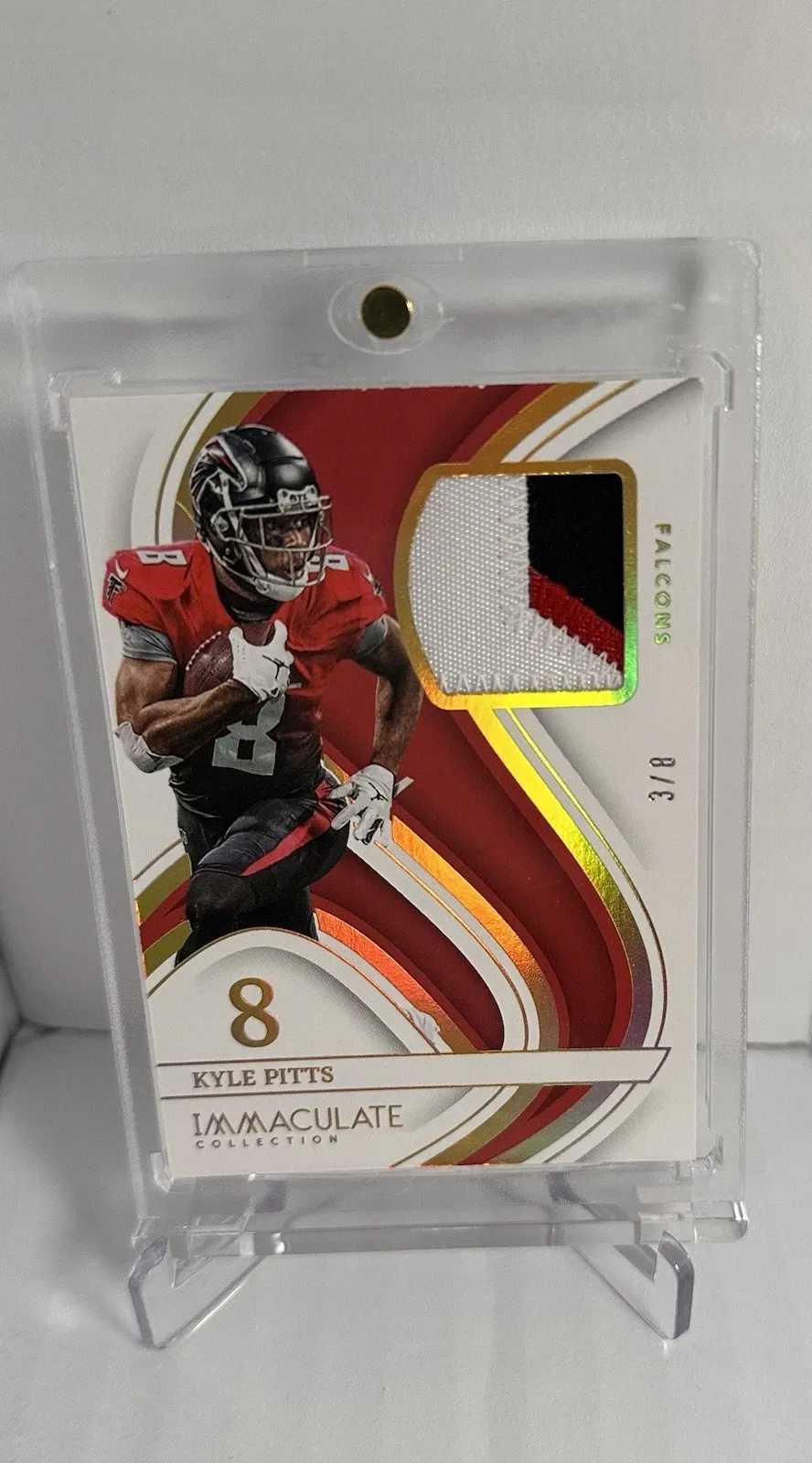 Multicolor logo patch card with visible stitching and layered jersey fabric